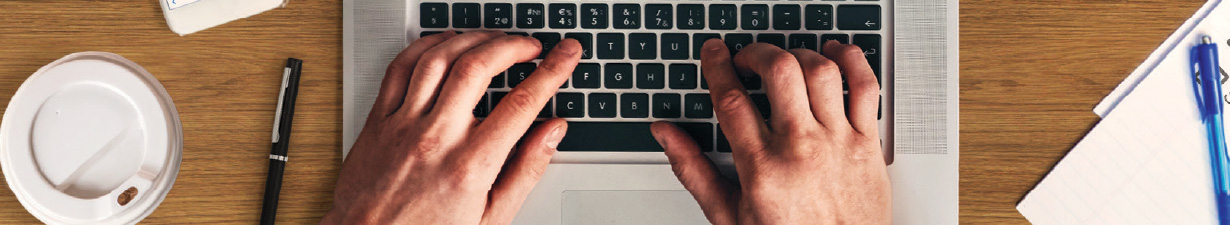 Close up of hands on a laptop keyboard